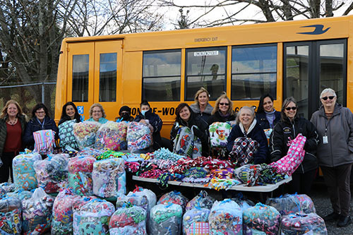 Staff with handmade donated blankets