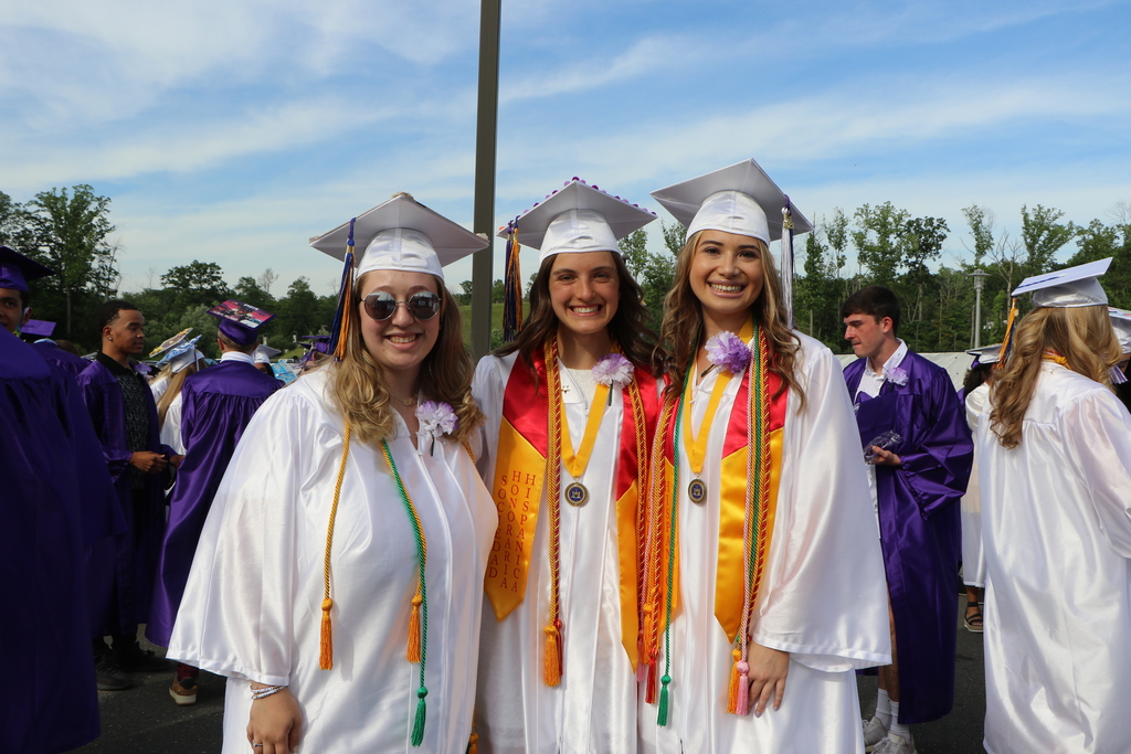 The class salutatorian (middle) and valedictorian (far right).