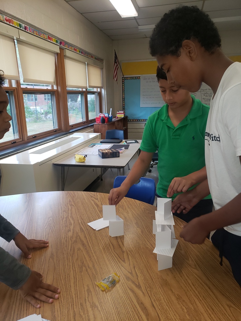 students building index card towers